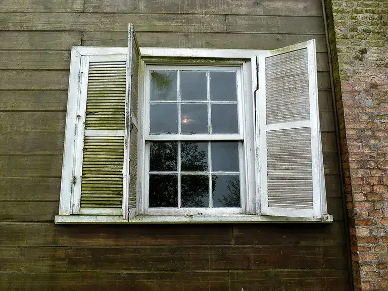 A bright room with a view of wooded hills